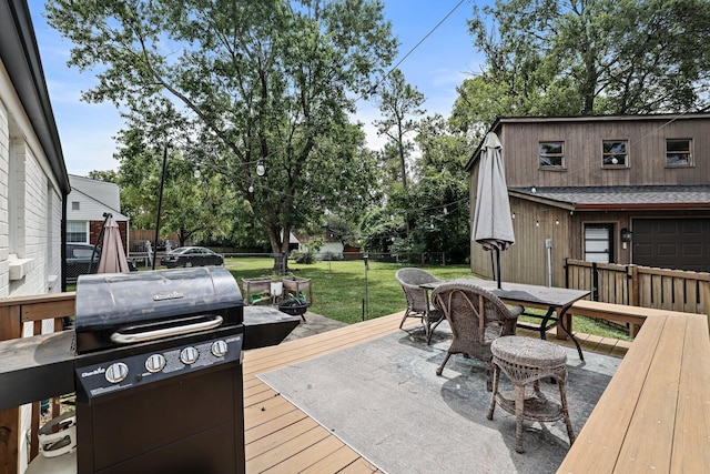 wooden deck with outdoor dining area and grilling area
