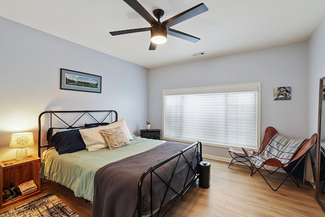 bedroom featuring light wood-type flooring, ceiling fan, and baseboards