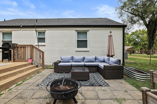 view of patio / terrace featuring an outdoor living space with a fire pit, fence, and a wooden deck