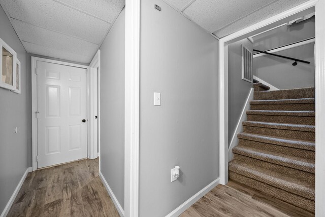 716 Ashwood Dr, Clarksville, TN 37043 - hallway featuring wood finished floors, a paneled ceiling, baseboards, and stairway
