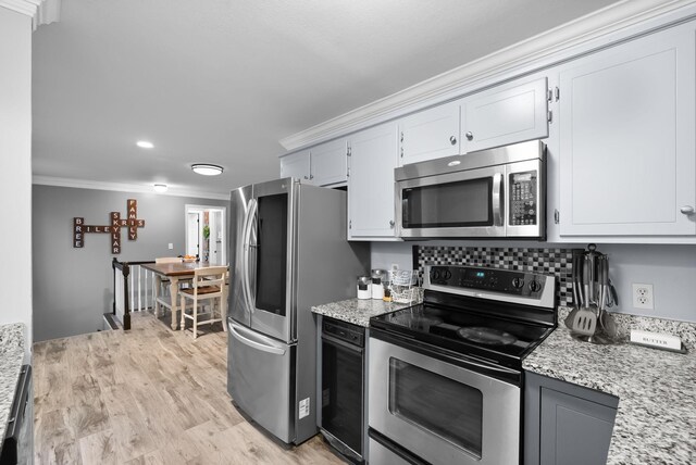 716 Ashwood Dr, Clarksville, TN 37043 - kitchen featuring appliances with stainless steel finishes, crown molding, light stone countertops, light wood-style flooring, and white cabinetry