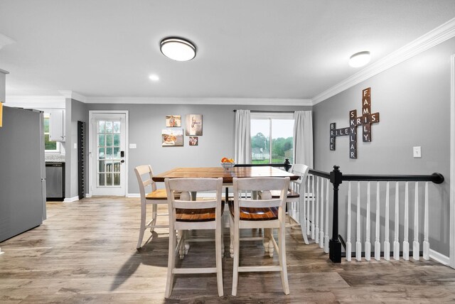 716 Ashwood Dr, Clarksville, TN 37043 - dining room with ornamental molding, plenty of natural light, light wood-style floors, and baseboards
