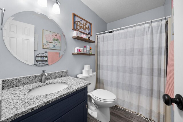 716 Ashwood Dr, Clarksville, TN 37043 - bathroom with toilet, wood finished floors, vanity, a shower with curtain, and a textured ceiling