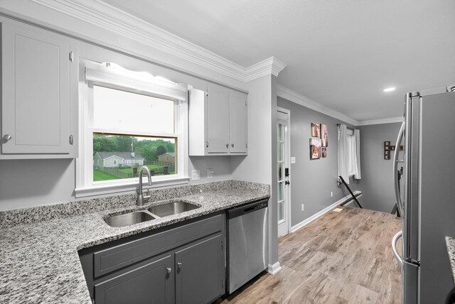 716 Ashwood Dr, Clarksville, TN 37043 - kitchen featuring stainless steel appliances, a sink, light stone countertops, crown molding, and light wood-style flooring