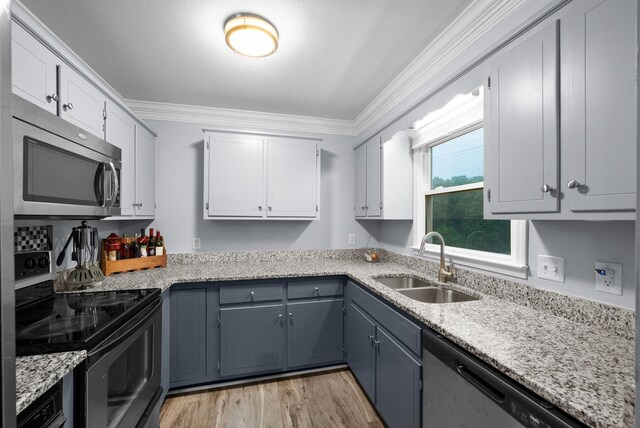 716 Ashwood Dr, Clarksville, TN 37043 - kitchen featuring stainless steel appliances, a sink, crown molding, white cabinetry, and light stone countertops