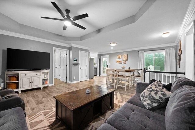 716 Ashwood Dr, Clarksville, TN 37043 - living room featuring ceiling fan, light wood finished floors, crown molding, baseboards, and a raised ceiling
