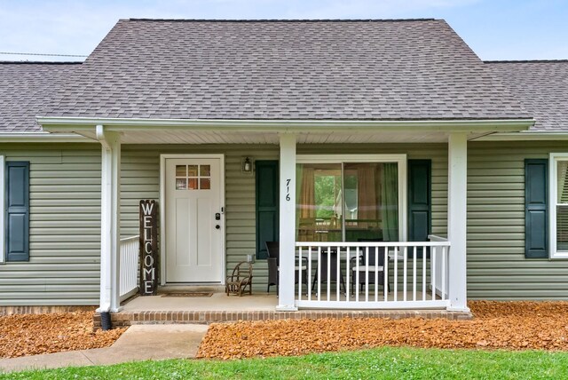 716 Ashwood Dr, Clarksville, TN 37043 - view of exterior entry with a porch and roof with shingles