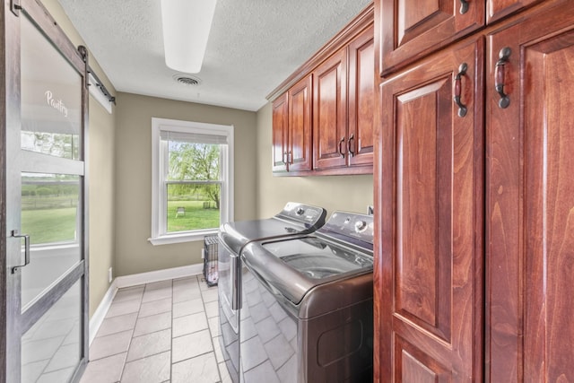 4484 N Pinson Rd, Portland, TN 37148 - washroom with cabinet space, washer and clothes dryer, baseboards, a textured ceiling, and light tile patterned floors