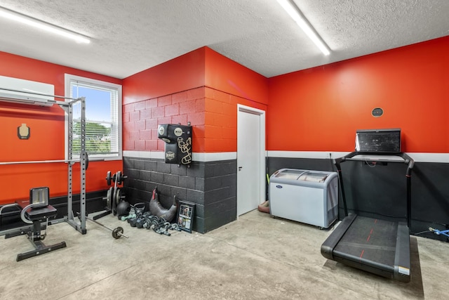 4484 N Pinson Rd, Portland, TN 37148 - workout room featuring a textured ceiling and a wall mounted air conditioner