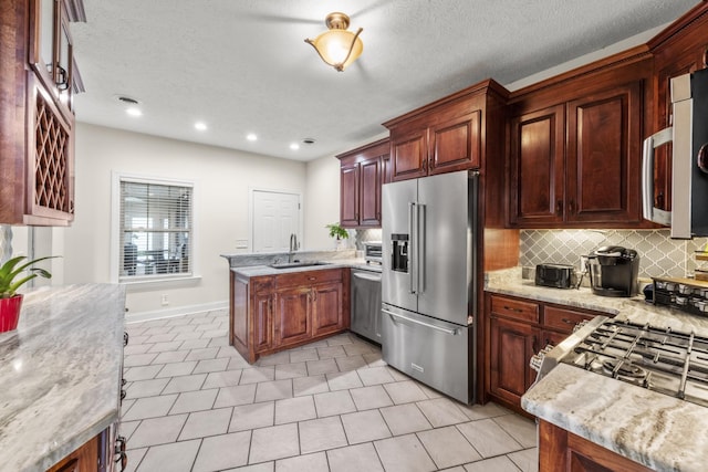 4484 N Pinson Rd, Portland, TN 37148 - kitchen with stainless steel appliances, a peninsula, backsplash, a sink, and baseboards