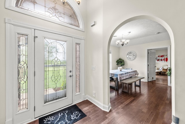 4484 N Pinson Rd, Portland, TN 37148 - entryway with arched walkways, a chandelier, dark wood-type flooring, and baseboards
