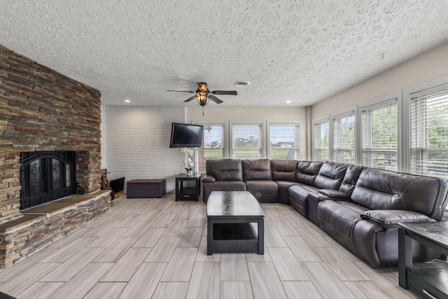 4484 N Pinson Rd, Portland, TN 37148 - living area featuring a textured ceiling, ceiling fan, a fireplace, plenty of natural light, and wood finish floors