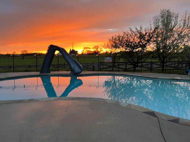 4484 N Pinson Rd, Portland, TN 37148 - pool at dusk with a water slide, fence, and a patio