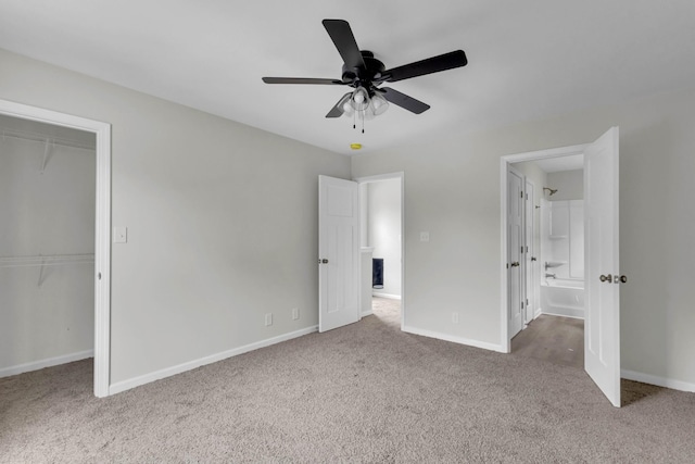 unfurnished bedroom featuring carpet, baseboards, and a closet