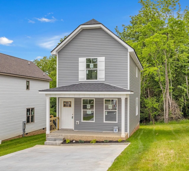view of front of house with covered porch, a front yard, and a shingled roof