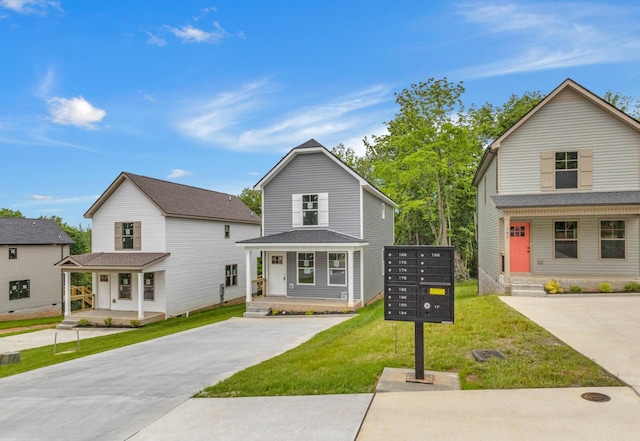 view of front of house with a front lawn, concrete driveway, and a porch