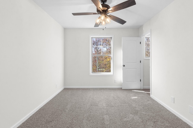 unfurnished room featuring carpet, baseboards, and a ceiling fan