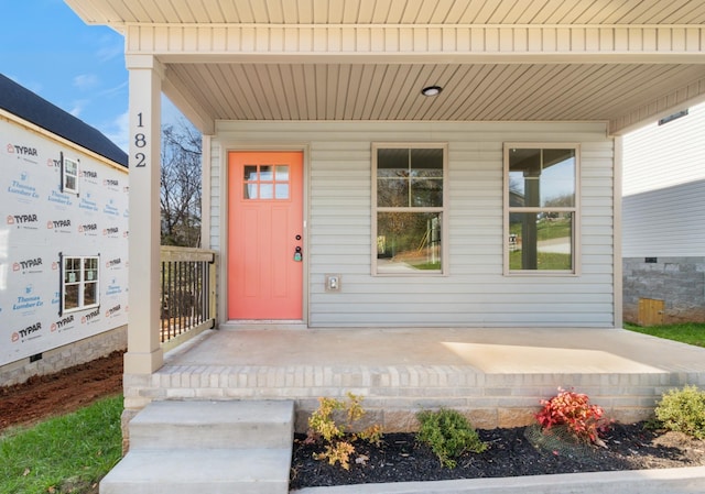 doorway to property featuring covered porch