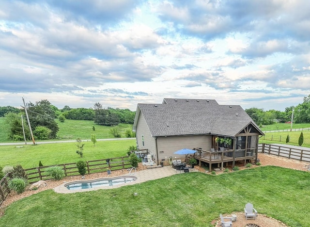 back of house featuring roof with shingles, a patio area, and a deck
