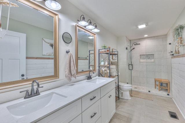 bathroom featuring a shower stall, toilet, tile patterned flooring, and double vanity