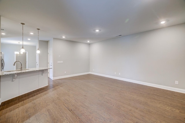 251 Grandstand Blvd, Gallatin, TN 37066 - unfurnished living room featuring a sink, dark wood-style flooring, recessed lighting, and baseboards