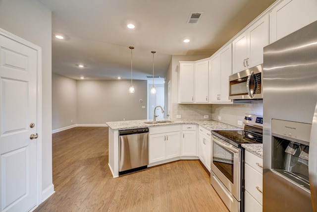 251 Grandstand Blvd, Gallatin, TN 37066 - kitchen featuring stainless steel appliances, a sink, light wood-style floors, a peninsula, and white cabinetry