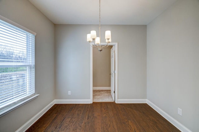 251 Grandstand Blvd, Gallatin, TN 37066 - empty room with plenty of natural light, dark wood-style floors, a chandelier, and baseboards