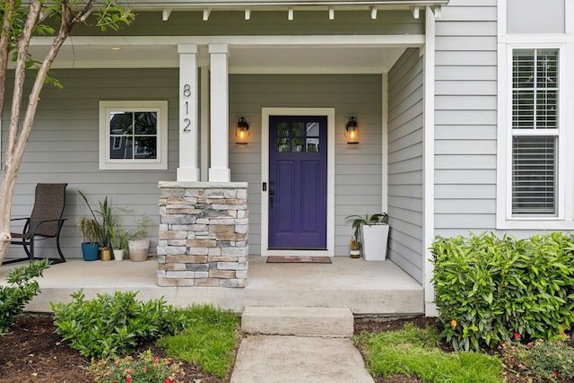 doorway to property featuring covered porch