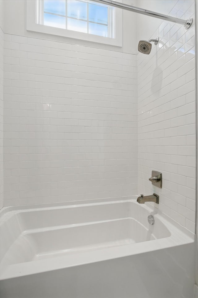 full bath featuring healthy amount of natural light and shower / bath combination
