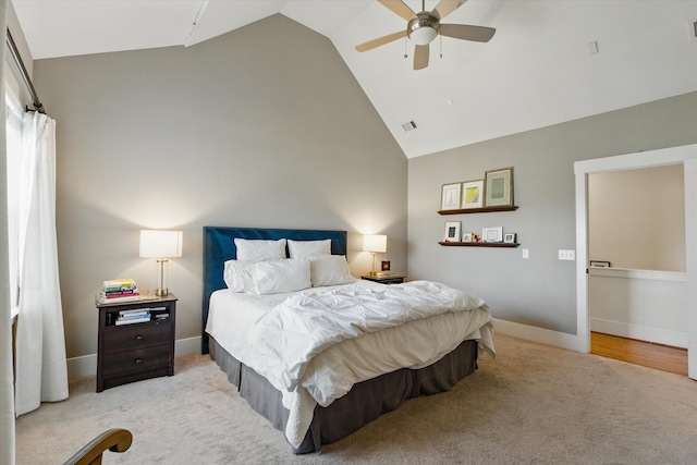 bedroom featuring light carpet, high vaulted ceiling, baseboards, and ceiling fan