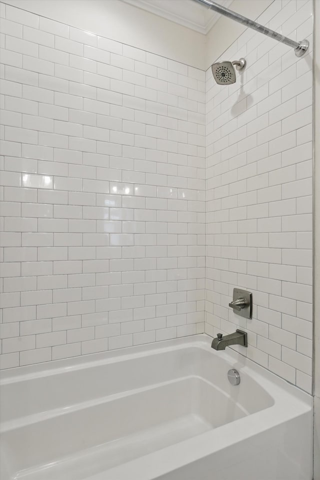 bathroom featuring ornamental molding and shower / washtub combination