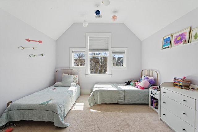 bedroom featuring light colored carpet and vaulted ceiling