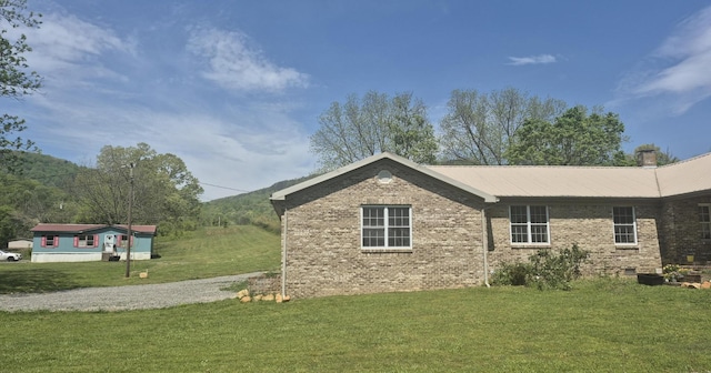 525527 Shady Grove Rd, Sequatchie, TN 37374 - view of side of home featuring brick siding and a yard