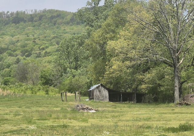 525527 Shady Grove Rd, Sequatchie, TN 37374 - view of yard featuring a wooded view, an outbuilding, and an outdoor structure
