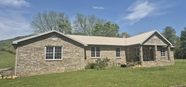 525527 Shady Grove Rd, Sequatchie, TN 37374 - rear view of house featuring a lawn, brick siding, and metal roof