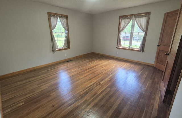 525527 Shady Grove Rd, Sequatchie, TN 37374 - unfurnished bedroom with multiple windows, dark wood-style floors, and baseboards