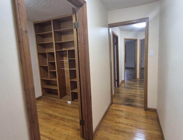 525527 Shady Grove Rd, Sequatchie, TN 37374 - hall with light wood-style flooring, a textured ceiling, and baseboards