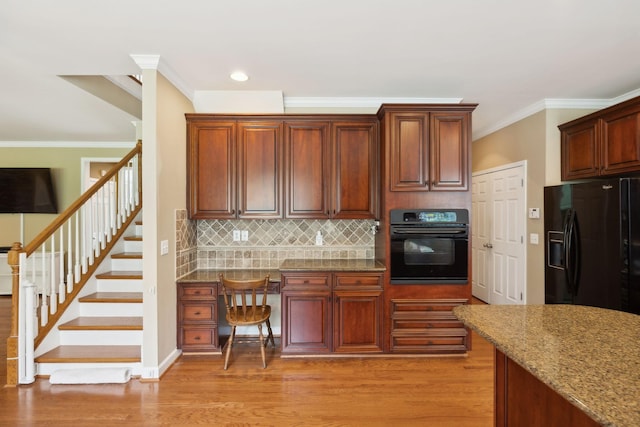 2041 Valley Brook Dr, Brentwood, TN 37027 - kitchen with black appliances, ornamental molding, light wood-type flooring, stone counters, and backsplash