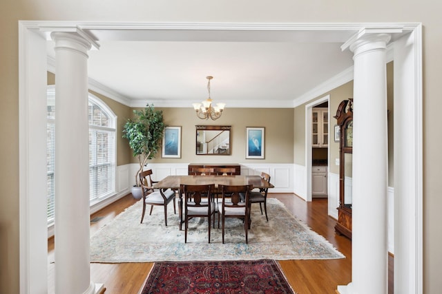 2041 Valley Brook Dr, Brentwood, TN 37027 - dining space featuring wood finished floors, a wainscoted wall, crown molding, a chandelier, and decorative columns