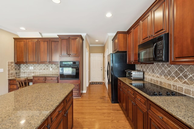 2041 Valley Brook Dr, Brentwood, TN 37027 - kitchen featuring black appliances, ornamental molding, backsplash, light stone counters, and light wood-style flooring