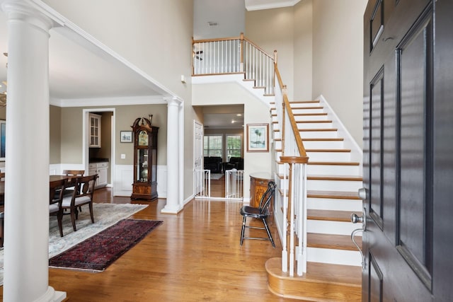 2041 Valley Brook Dr, Brentwood, TN 37027 - entrance foyer featuring decorative columns, crown molding, stairway, wood finished floors, and a wainscoted wall