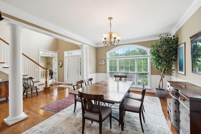 2041 Valley Brook Dr, Brentwood, TN 37027 - dining space featuring stairs, ornate columns, wood finished floors, a wainscoted wall, and ornamental molding