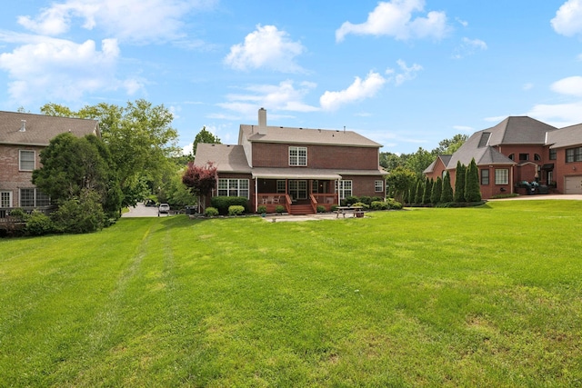 2041 Valley Brook Dr, Brentwood, TN 37027 - rear view of house featuring a patio, a yard, and a chimney