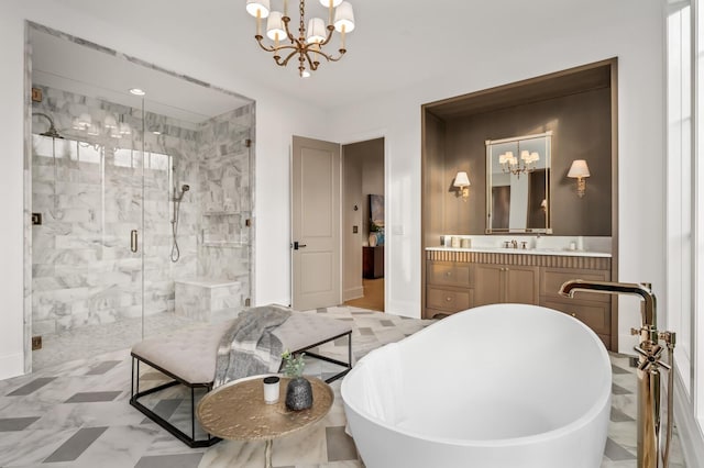 bathroom featuring a chandelier, a stall shower, a freestanding bath, and vanity