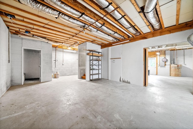 unfinished below grade area featuring concrete block wall
