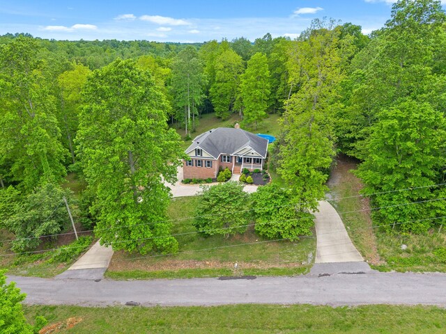 view of subject property with a forest