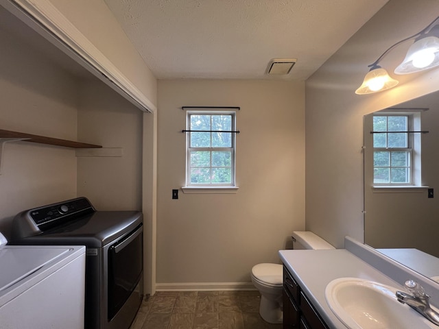 105 Vernon Traylor Dr, Smyrna, TN 37167 - half bath with washer and clothes dryer, toilet, baseboards, and vanity