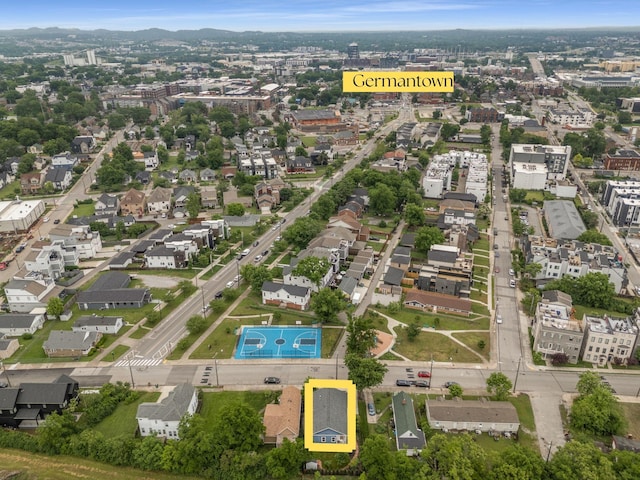 aerial view of property and surrounding area featuring nearby suburban area