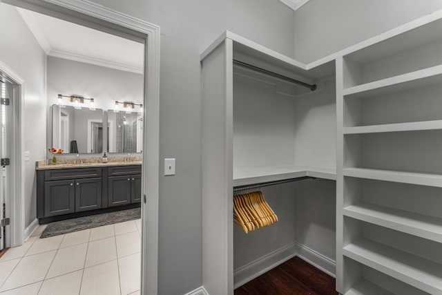 walk in closet featuring a sink and light tile patterned floors