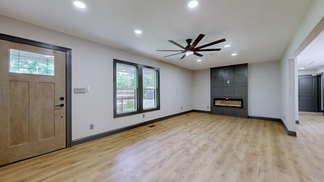 2038 Ogburn Chapel Rd, Clarksville, TN 37042 - unfurnished living room featuring healthy amount of natural light, a ceiling fan, recessed lighting, and light wood-type flooring